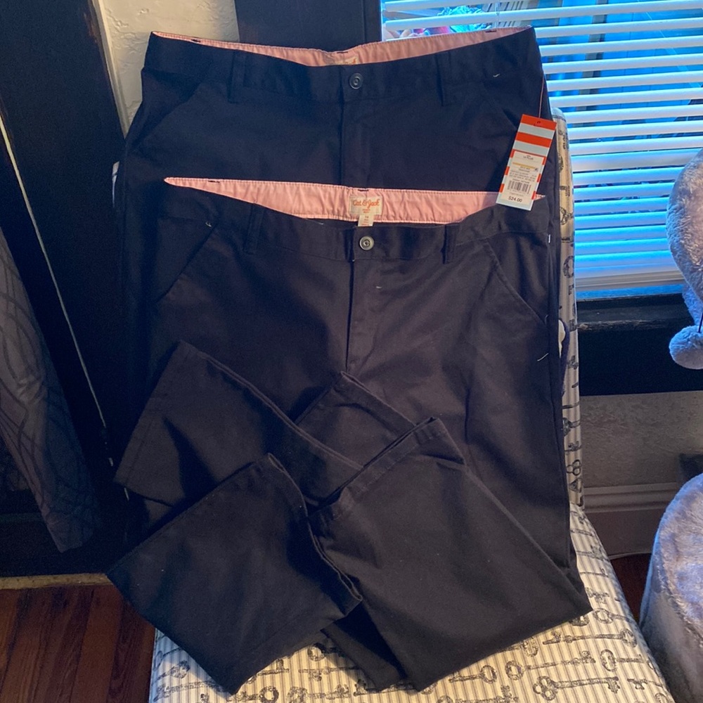 Two pairs of black school uniform pants.